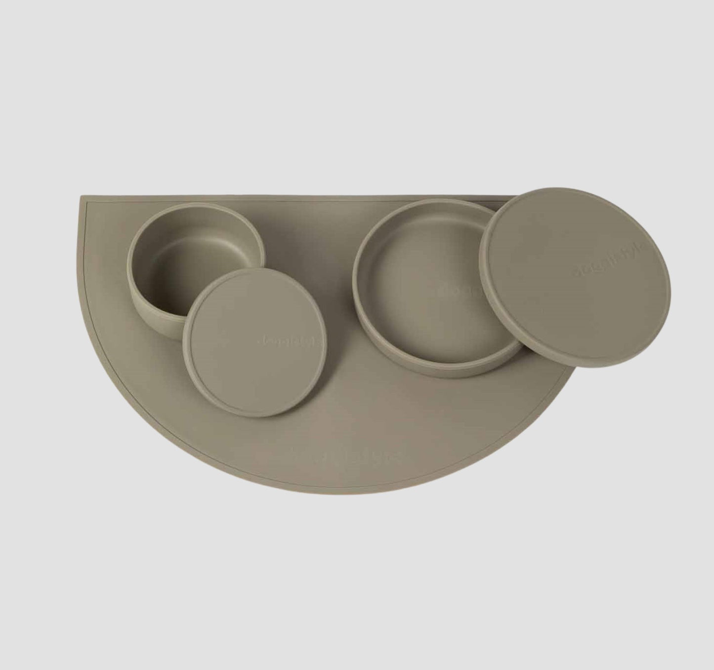 Food grade non-slip silicone dog feeding station which includes a dog bowls with lids & a dog food mat in green.