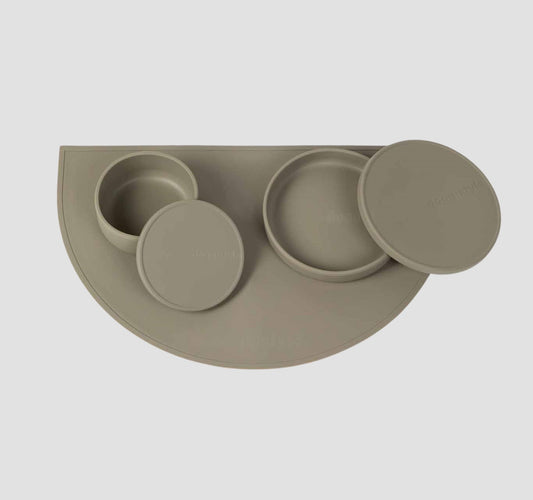 Food grade non-slip silicone dog feeding station which includes a dog bowls with lids & a dog food mat in green.