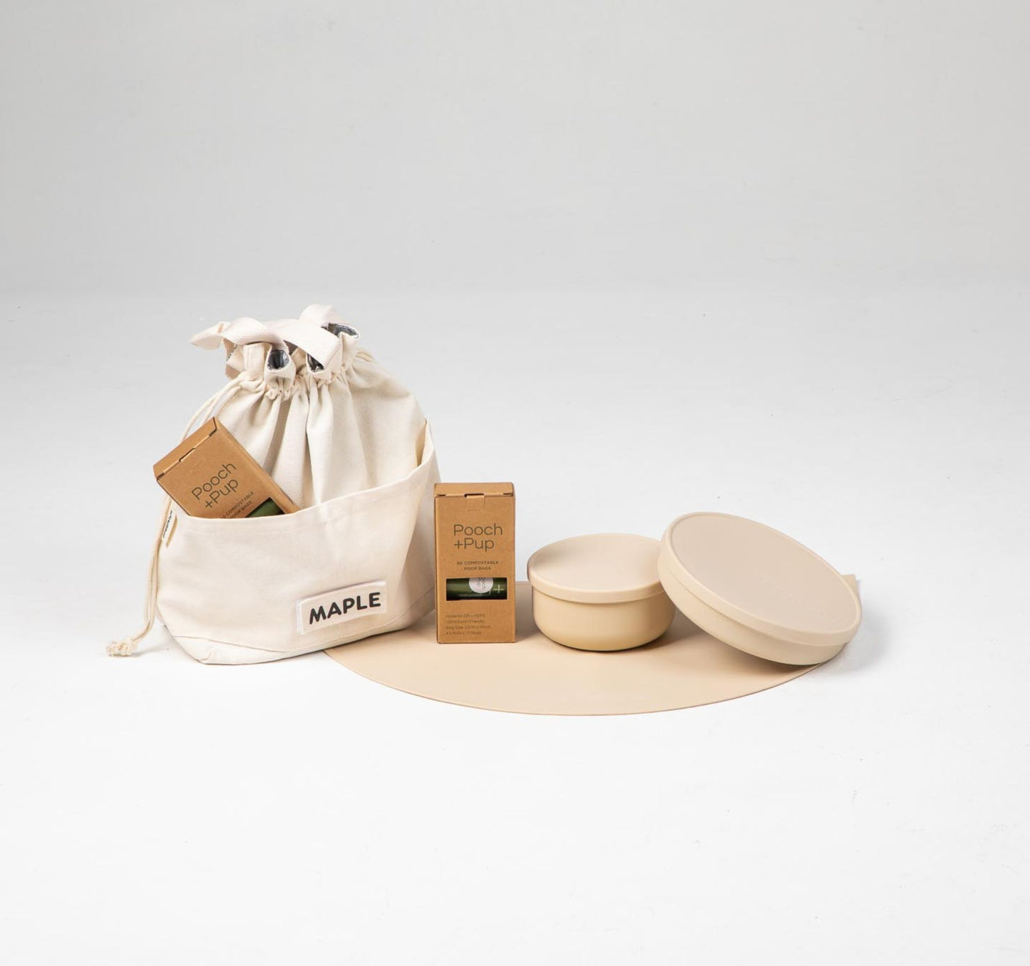 Dog food cooler travel bag & dog bowls with lid in beige plus compostable poop bags.