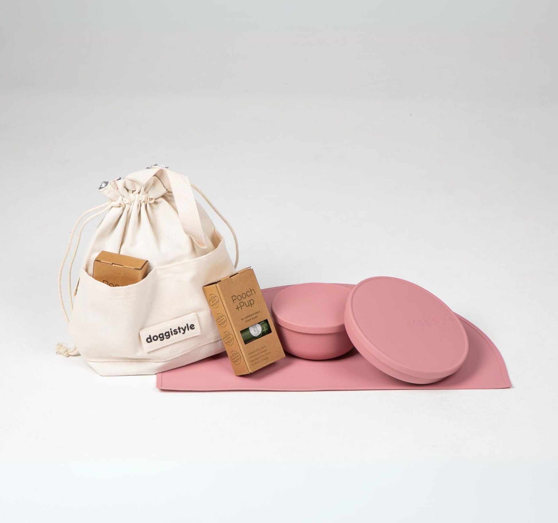 Dog food cooler travel bag & dog bowls with lid in pink plus compostable poop bags.